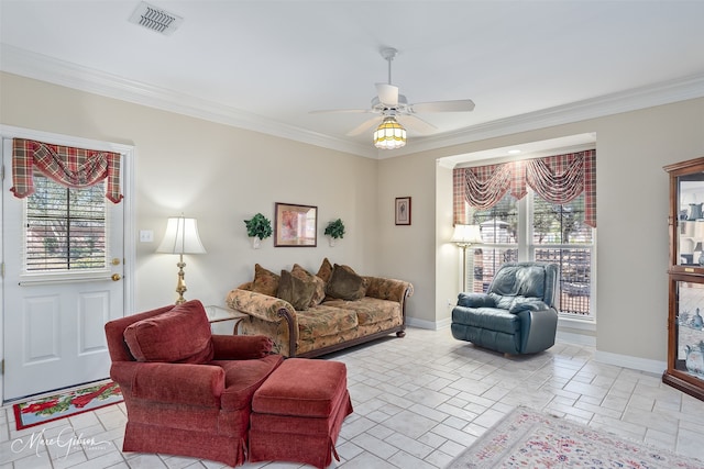 living area featuring ornamental molding, visible vents, baseboards, and a ceiling fan