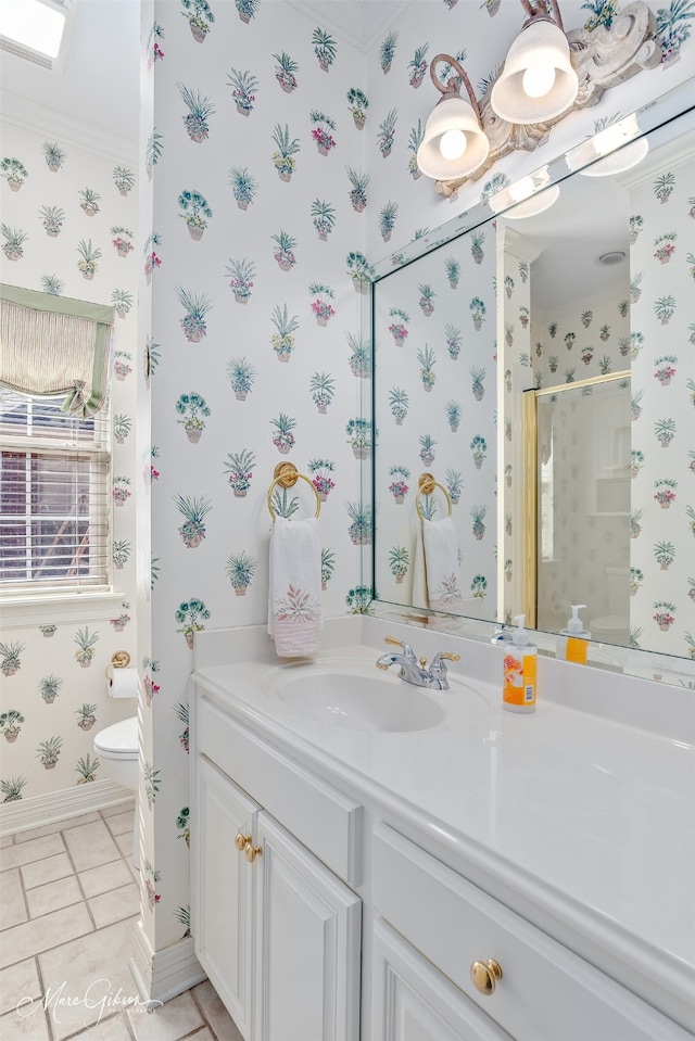 bathroom featuring tile patterned flooring, toilet, vanity, baseboards, and wallpapered walls