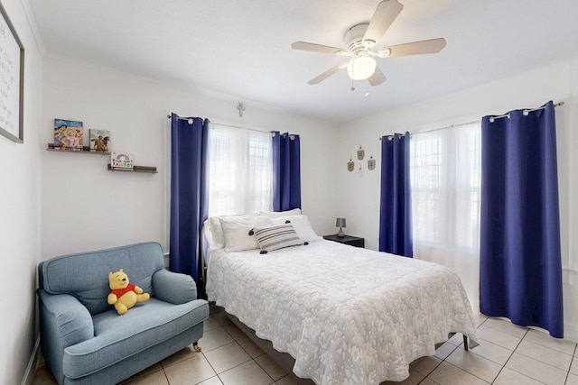 bedroom with light tile patterned floors, multiple windows, and a ceiling fan