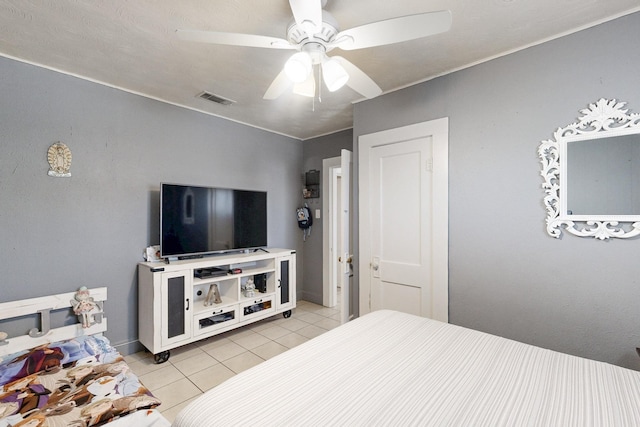 bedroom featuring ceiling fan, light tile patterned flooring, and visible vents