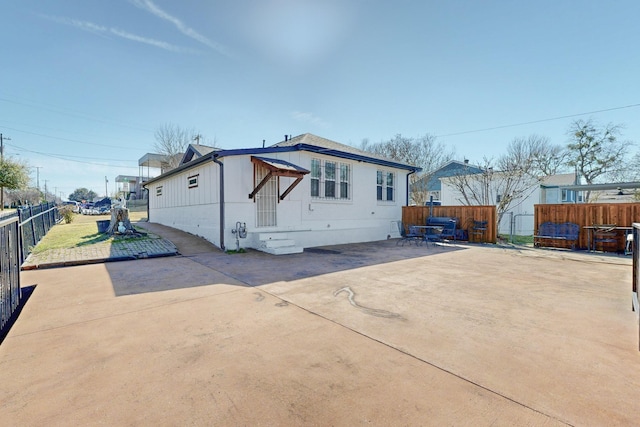 rear view of house featuring a patio area and fence