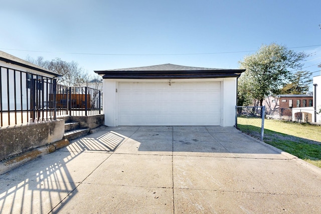 detached garage featuring fence