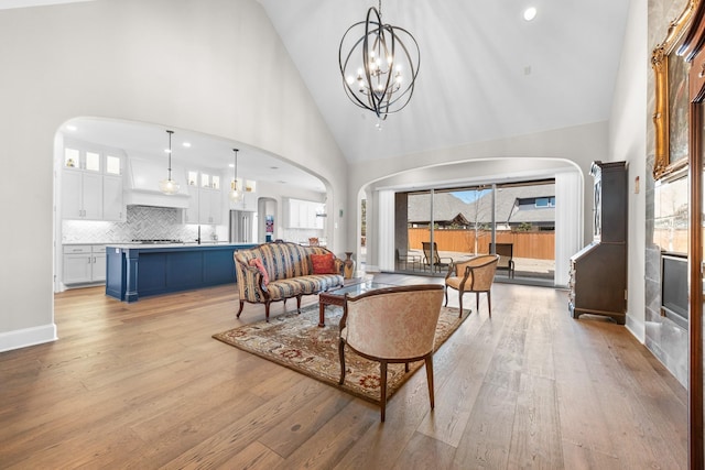 living room featuring light wood-type flooring and arched walkways