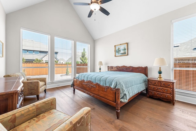 bedroom with a ceiling fan, high vaulted ceiling, and hardwood / wood-style floors