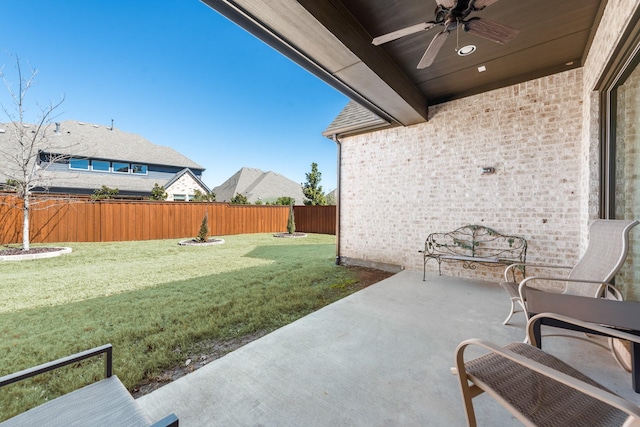 view of patio with a fenced backyard and ceiling fan