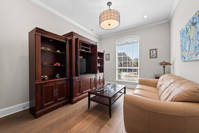 living area with light wood finished floors, baseboards, crown molding, and recessed lighting