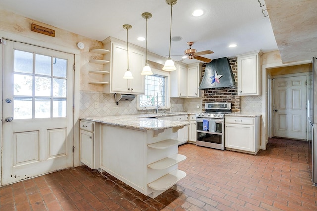 kitchen with a peninsula, wall chimney range hood, double oven range, and open shelves