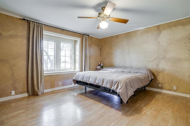 bedroom with ceiling fan, ornamental molding, light wood-style flooring, and baseboards