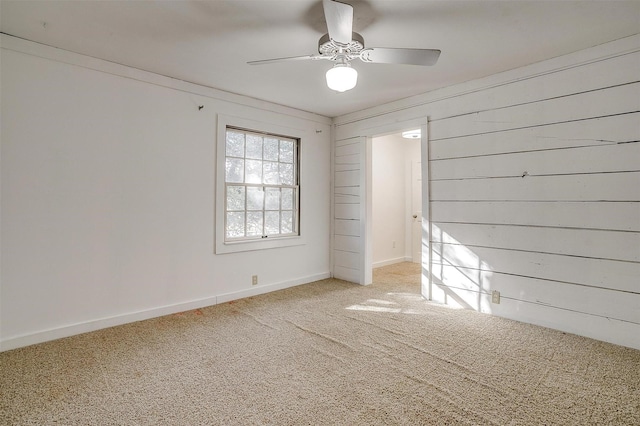 unfurnished room with light colored carpet, ceiling fan, and baseboards