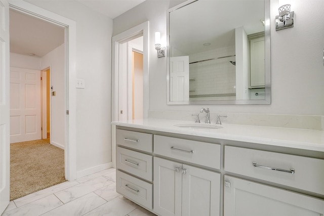 bathroom with a shower, marble finish floor, vanity, and baseboards