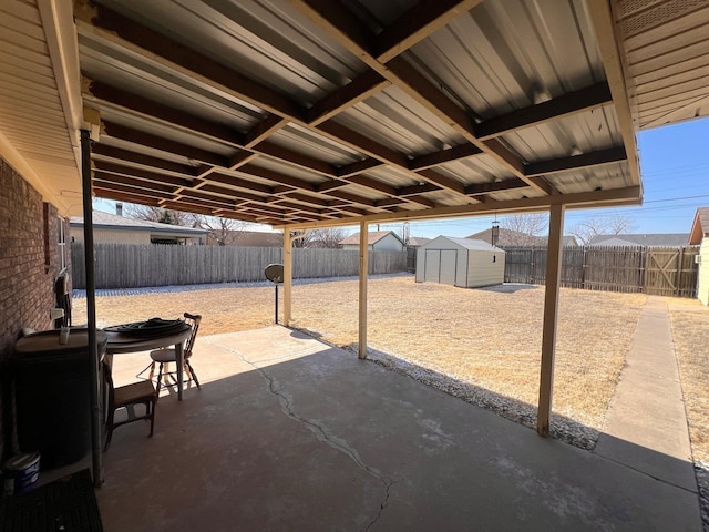 view of patio featuring an outbuilding, a shed, and a fenced backyard