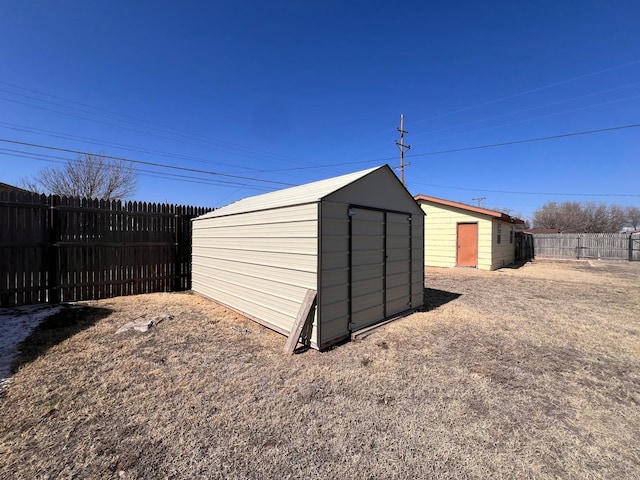 view of shed with a fenced backyard