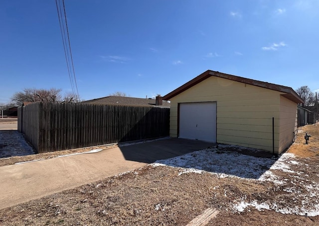 detached garage with driveway and fence