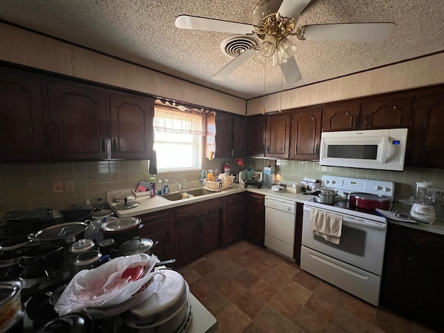 kitchen featuring white appliances, decorative backsplash, light countertops, dark brown cabinets, and a sink