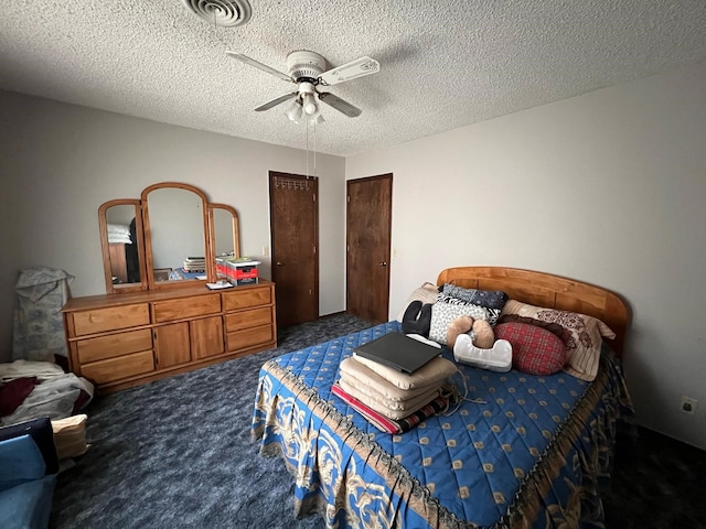 carpeted bedroom with two closets, ceiling fan, visible vents, and a textured ceiling