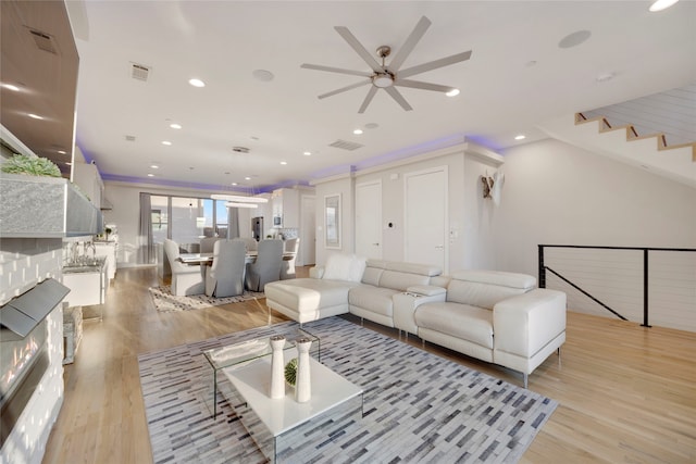 living room featuring recessed lighting, visible vents, and light wood finished floors