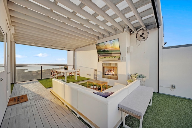 wooden deck featuring an outdoor living space with a fireplace