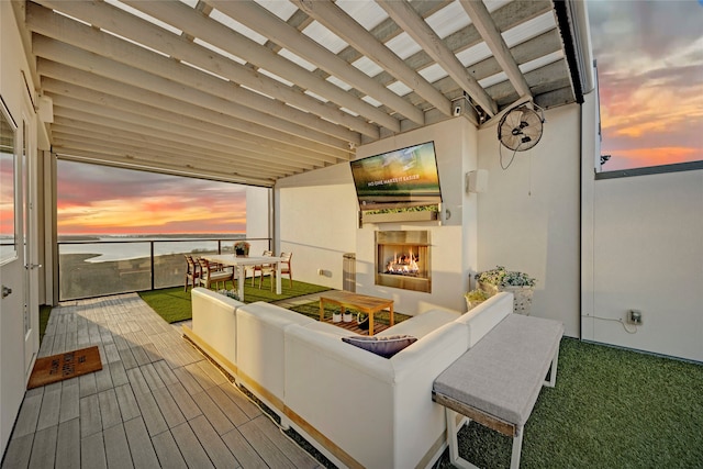 interior space with an outdoor living space with a fireplace