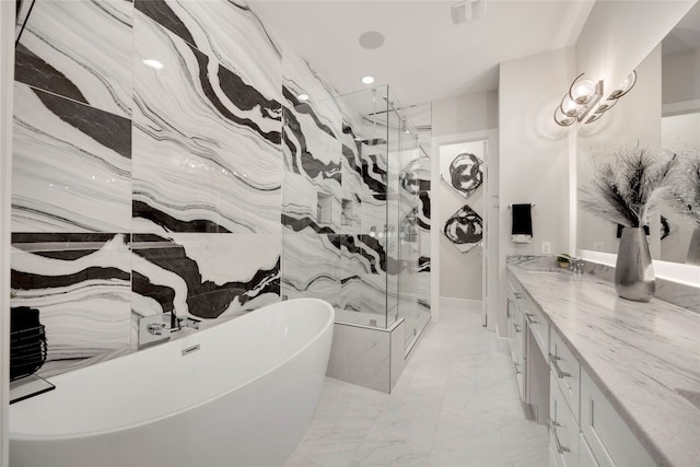 full bath featuring a marble finish shower, recessed lighting, a freestanding tub, marble finish floor, and vanity