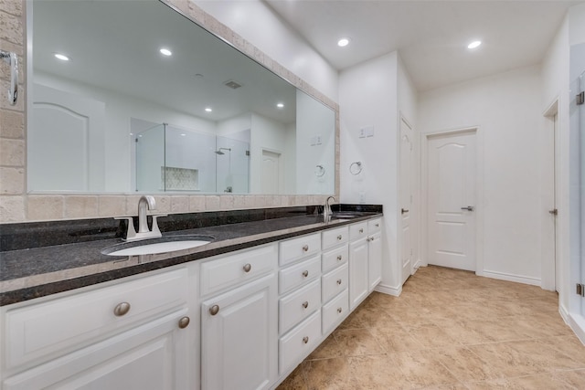 bathroom featuring double vanity, recessed lighting, visible vents, a stall shower, and a sink