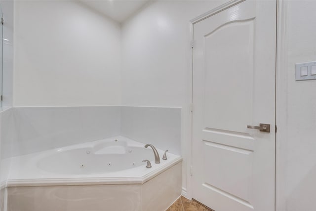 bathroom featuring a tub with jets