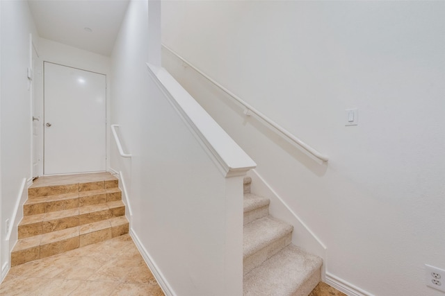 stairs featuring tile patterned flooring