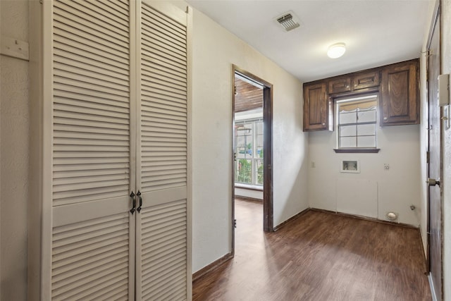 1878 Trail Ridge Dr, Lewisville, TX 75077 - laundry area with washer hookup, dark wood-style flooring, baseboards, and cabinet space