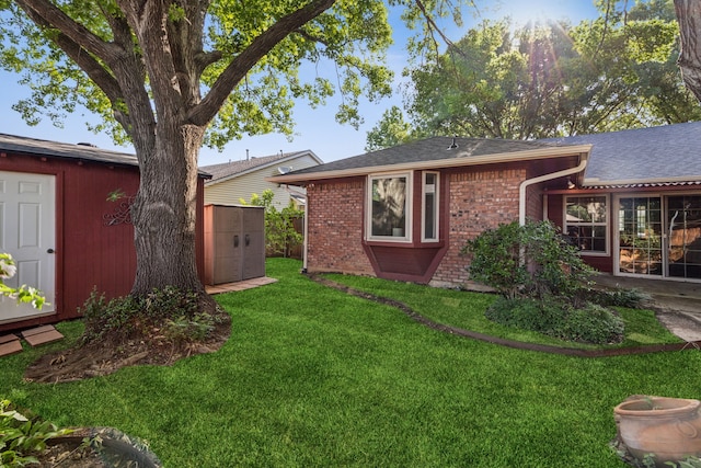 1878 Trail Ridge Dr, Lewisville, TX 75077 - back of property with a yard, brick siding, and roof with shingles