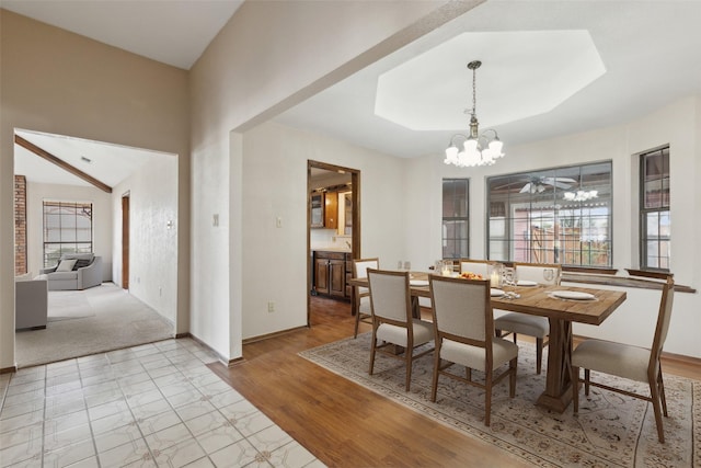 1878 Trail Ridge Dr, Lewisville, TX 75077 - dining room featuring a chandelier, baseboards, light wood-type flooring, and a raised ceiling
