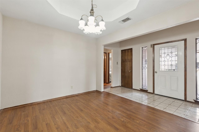 1878 Trail Ridge Dr, Lewisville, TX 75077 - entrance foyer with a chandelier, light wood finished floors, baseboards, and a raised ceiling