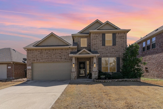 traditional home with brick siding, concrete driveway, and an attached garage