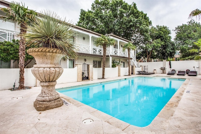 view of pool with a fenced in pool, a patio, stairway, a gate, and fence