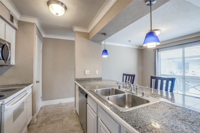 kitchen featuring pendant lighting, crown molding, stainless steel appliances, tile counters, and a sink