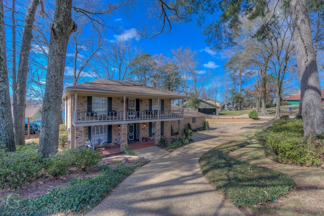 view of front of property featuring covered porch and brick siding