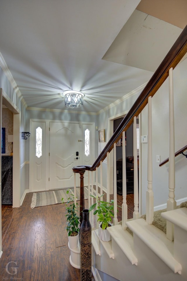 foyer entrance featuring stairs, ornamental molding, wood finished floors, and a wealth of natural light