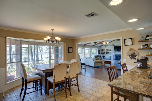 dining space featuring an inviting chandelier, light tile patterned floors, visible vents, and ornamental molding