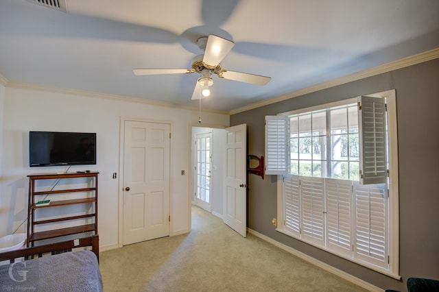 carpeted bedroom featuring baseboards, ornamental molding, and ceiling fan