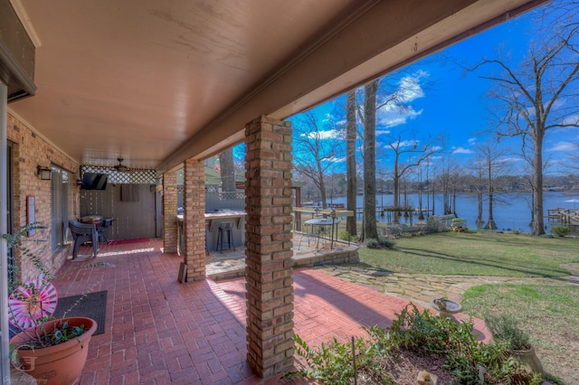 view of patio / terrace featuring a water view and outdoor dry bar