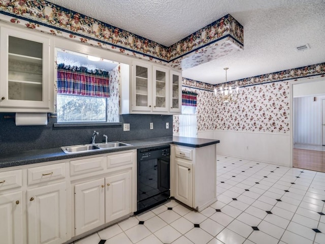 kitchen featuring wallpapered walls, black dishwasher, wainscoting, dark countertops, and a sink