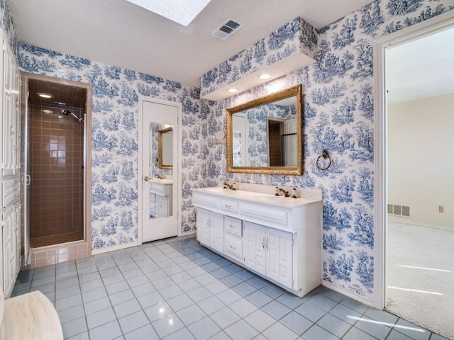 full bath featuring tile patterned floors, visible vents, a shower stall, and wallpapered walls