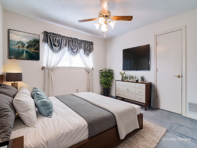 bedroom with carpet, visible vents, and a ceiling fan