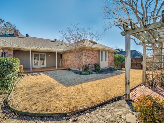 rear view of house featuring brick siding, a patio area, fence, and a pergola