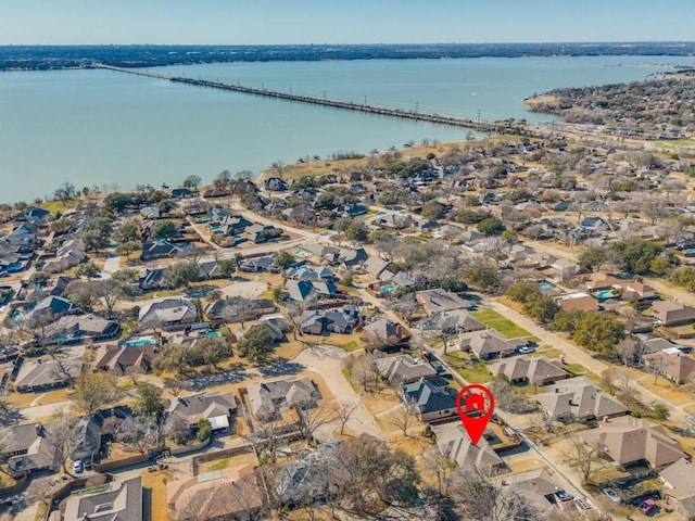 drone / aerial view featuring a water view and a residential view