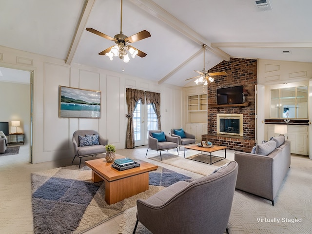 living area with light carpet, built in features, vaulted ceiling with beams, a fireplace, and a decorative wall