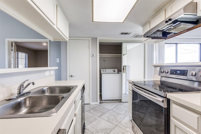 kitchen featuring stainless steel range with electric stovetop, a sink, light tile patterned flooring, extractor fan, and washer / dryer