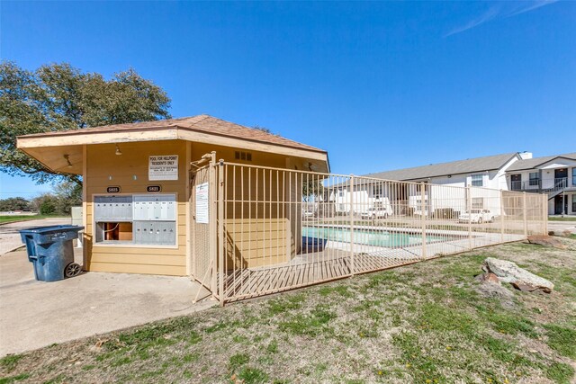 community pool with mail area and fence