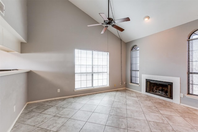 unfurnished living room with a ceiling fan, light tile patterned floors, a fireplace, and baseboards