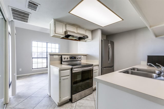 kitchen featuring under cabinet range hood, visible vents, stainless steel appliances, and a sink