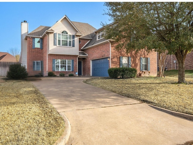 traditional home with a garage, brick siding, concrete driveway, a chimney, and a front yard