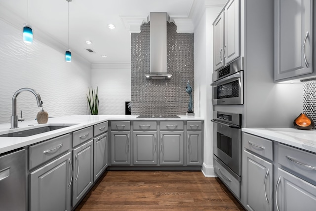 kitchen with dark wood-style floors, stainless steel appliances, gray cabinetry, a sink, and wall chimney range hood